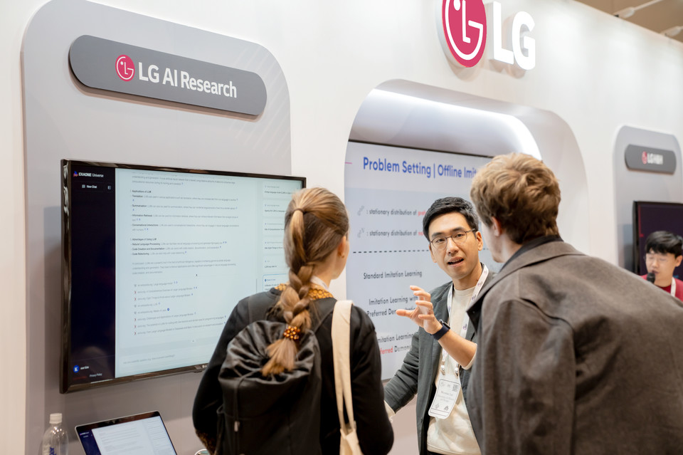 LG AI연구원 뉴립스 2023 LG 통합 부스에서 이문태 LG AI연구원 어드밴스드 ML랩장이 연구자들과 대화를 나누고 있다